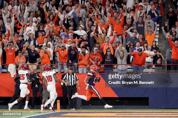 Sean Tucker of the Syracuse Orange scores a touchdown during the fourth quarter against the North Carolina State Wolfpack at JMA Wireless Dome on...
