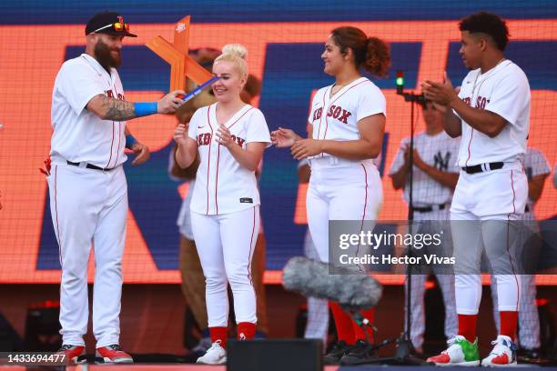 Jonny Gomes, Liv Cooke, Jocelyn Alo and Enmanuel Valdez of the Boston Red Sox celebrate with the champions trophy of the FTX MLB Home Run Derby X at...