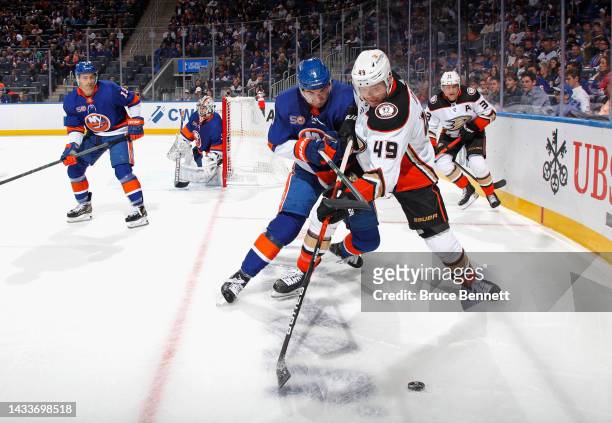 Adam Pelech of the New York Islanders and Max Jones of the Anaheim Ducks battle for the puck during the first period at the UBS Arena on October 15,...