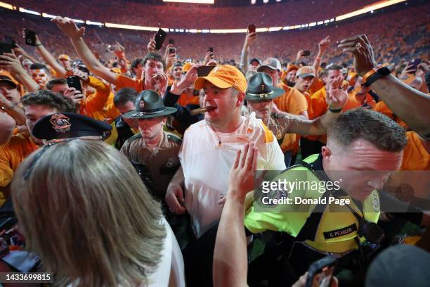 Head coach Josh Heupel of the Tennessee Volunteers celebrates a win over the Alabama Crimson Tide with a cigar at Neyland Stadium on October 15, 2022...