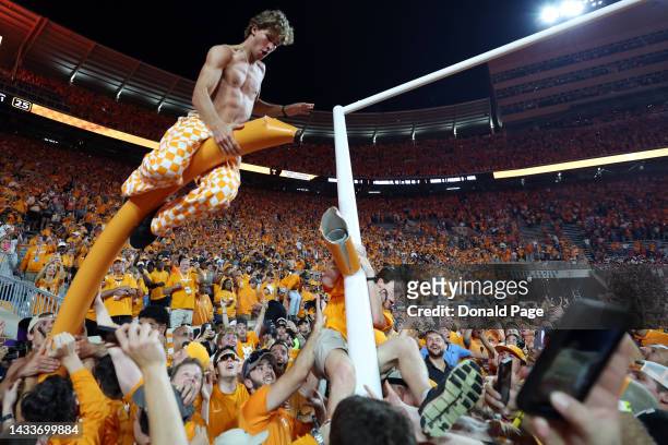 Tennessee Volunteers fans tear down the goal post after the Tennessee Volunteers defeated the Alabama Crimson Tide at Neyland Stadium on October 15,...