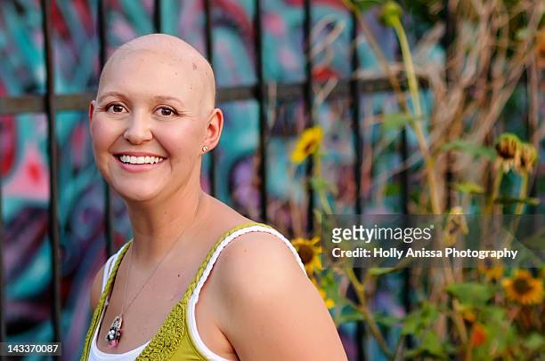 bald woman with cancer in front of graffiti wall - hair loss stock pictures, royalty-free photos & images