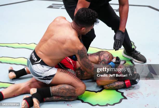 Jonathan Martinez punches Cub Swanson in a bantamweight fight during the UFC Fight Night event at UFC APEX on October 15, 2022 in Las Vegas, Nevada.