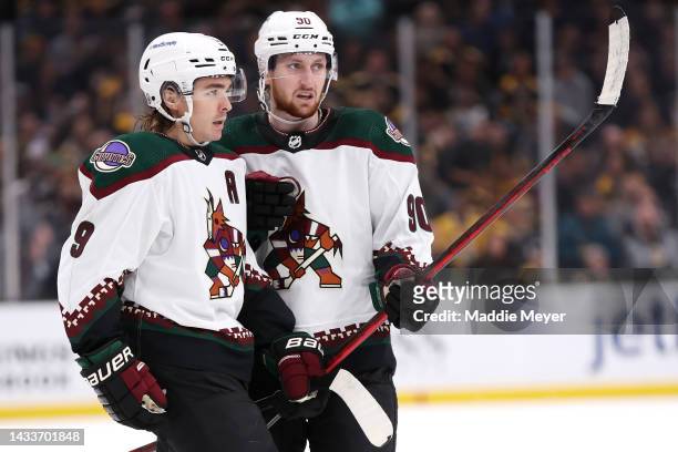 Clayton Keller of the Arizona Coyotes celebrates with J.J. Moser after scoring a goal against the Boston Bruins during the second period at TD Garden...
