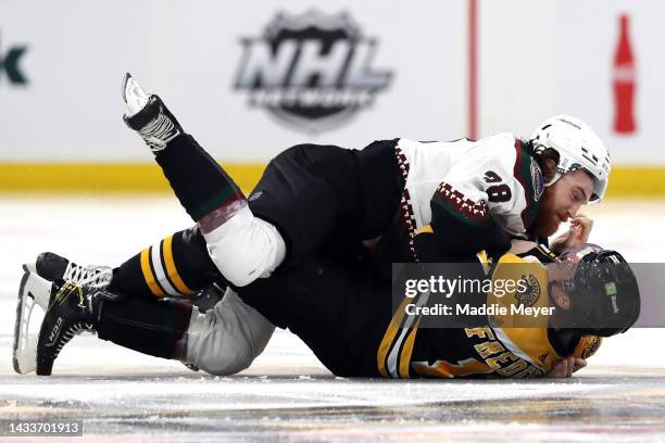 Liam O'Brien of the Arizona Coyotes fights Trent Frederic of the Boston Bruins during the second period at TD Garden on October 15, 2022 in Boston,...