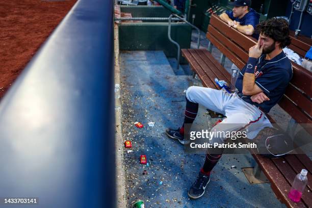Dansby Swanson of the Atlanta Braves sits in the dugout dejected after losing to the Philadelphia Phillies in game four of the National League...