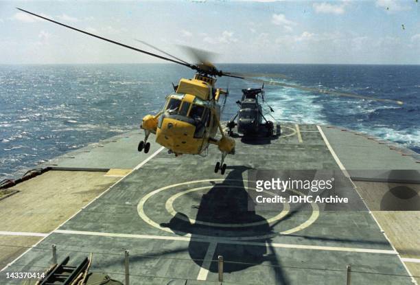 Helicopters landing on the afterdeck helipad of the Cunard liner 'RMS Queen Elizabeth 2', which has been requisitioned as a British troopship during...