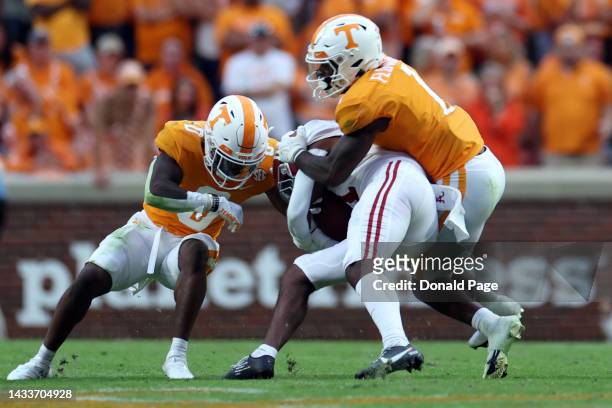 Defensive back Doneiko Slaughter of the Tennessee Volunteers and defensive back Trevon Flowers of the Tennessee Volunteers tackle wide receiver...