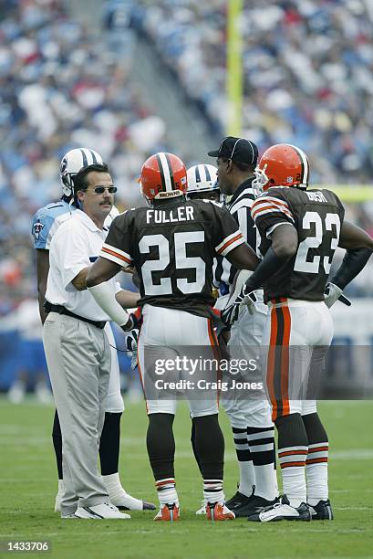 Umpire Chad Brown listens to the argument s of head coach Jeff Fisher of the Tennessee Titans argues and cornerback Corey Fuller and safety Devin...