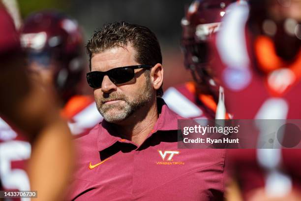 Head coach Brent Pry of the Virginia Tech Hokies runs on the field during the college football game between the Virginia Tech Hokies and the Miami...