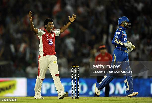 Kings XI Punjab bowler Parvinder Awana celebrates the wicket of Mumbai Indians batsman Harbhajan Singh during the IPL Twenty20 cricket match between...