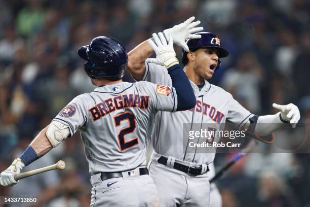 Jeremy Pena of the Houston Astros reacts with Jose Altuve after hitting a solo home run during the eighteenth inning against the Seattle Mariners in...