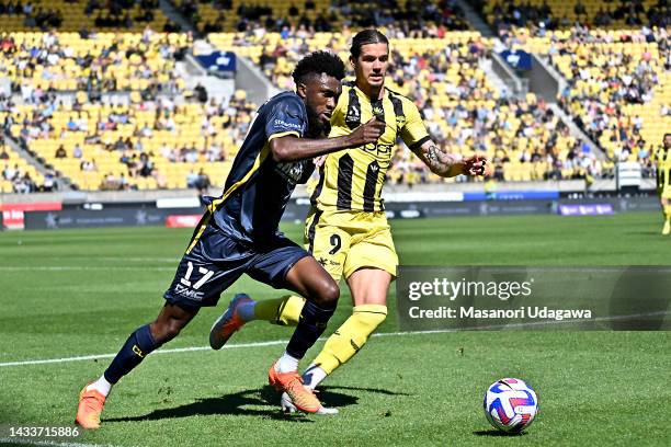 Kelechi John of the Mariners and Oskar Zawada of the Phoenix compete for the ball during the round two A-League Men's match between Wellington...