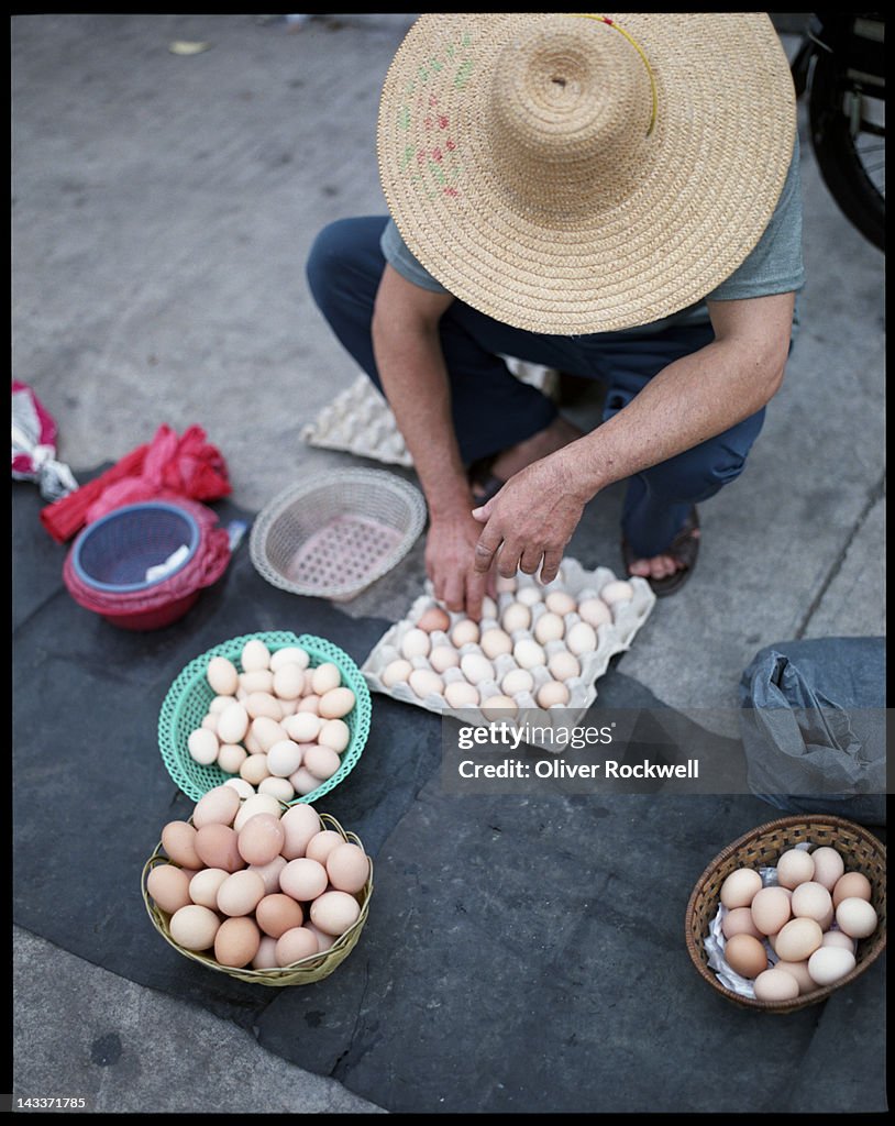 Man selling eggs in market