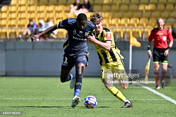 Béni Nkololo of the Mariners and Lucas Mauragis of the Phoenix compete for the ball during the round two A-League Men's match between Wellington...