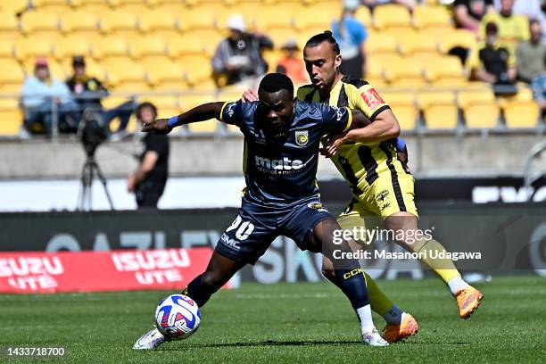 Paul Ayongo of the Mariners and Clayton Lewis of the Phoenix compete for the ball during the round two A-League Men's match between Wellington...