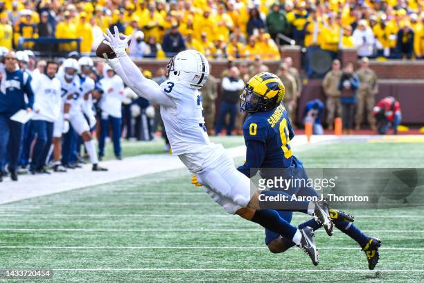 Parker Washington of the Penn State Nittany Lions attempts to catch a pass against Mike Sainristil of the Michigan Wolverines during the second half...