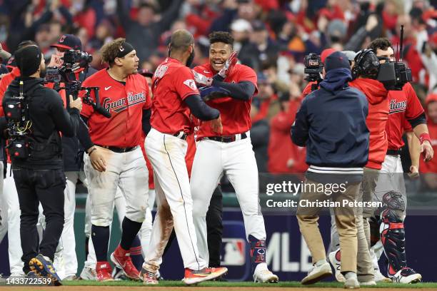 Oscar Gonzalez of the Cleveland Guardians celebrates with his team after hitting a two run single during the ninth inning against the New York...