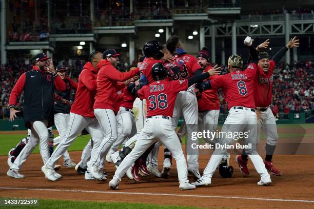 Oscar Gonzalez of the Cleveland Guardians celebrates with his team after hitting a two run single during the ninth inning against the New York...