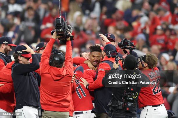 Oscar Gonzalez of the Cleveland Guardians celebrates with his team after hitting a two run single during the ninth inning against the New York...