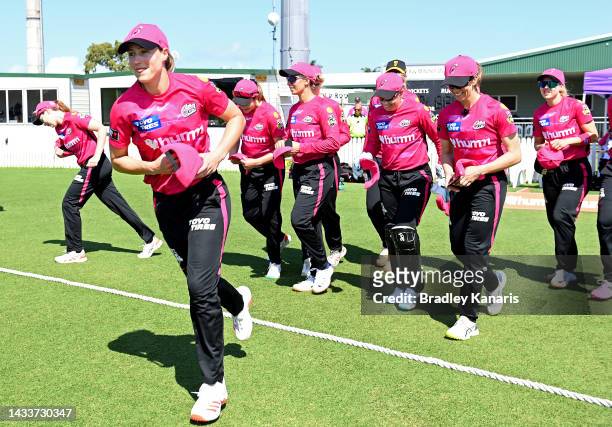 Ellyse Perry of the Sixers leads her team onto the field during the Women's Big Bash League match between the Sydney Sixers and the Melbourne Stars...