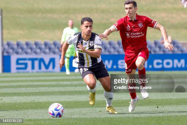 Daniel Arzani of Macarthur FC and Isaias Sanchez Cortes of Adelaide United run for the ball during the round two A-League Men's match between...