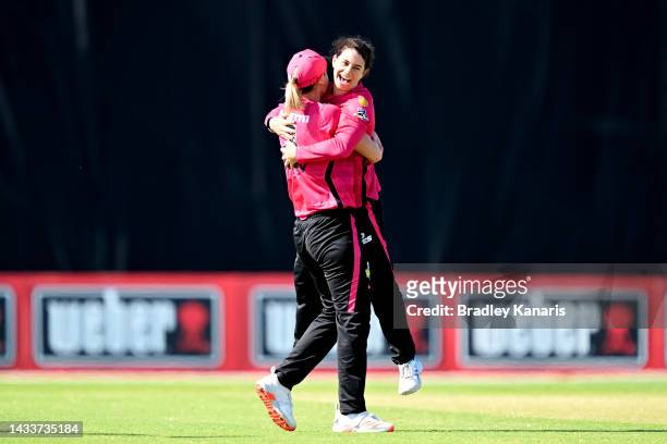 Nicole Bolton of the Sixers celebrates with team mate Ellyse Perry of the Sixers after taking the wicket of Bess Heath of the Stars during the...