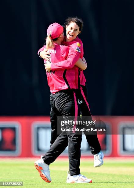 Nicole Bolton of the Sixers celebrates with team mate Ellyse Perry of the Sixers after taking the wicket of Bess Heath of the Stars during the...