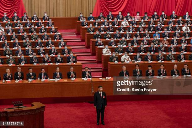 Chinese President Xi Jinping, bottom, centre, is applauded by senior members of the government and delegates as he stands after his speech during the...