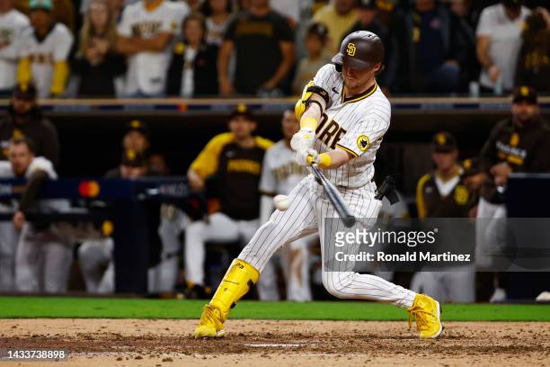 Jake Cronenworth of the San Diego Padres hits a two-run RBI single during the seventh inning against the Los Angeles Dodgers in game four of the...