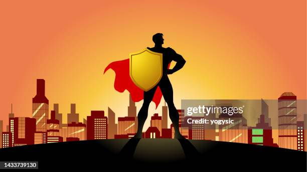 vector superhero silhouette holding shield with city skyline background stock illustration - superhero shield stock illustrations