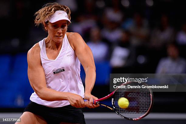 Greta Arn of Hungary plays a backhand in her match against Agnieszka Radwanska of Poland during day three of the WTA Porsche Tennis Grand Prix at...