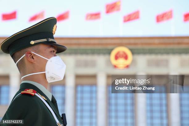 Member of security staff keeps watch on Tiananmen Square before the opening session of the 20th National Congress of the Communist Party of China at...