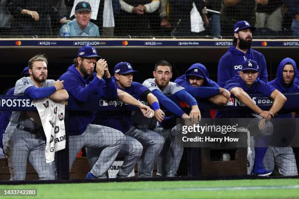 The Los Angeles Dodgers dugout reacts during the ninth inning against the San Diego Padres in game four of the National League Division Series at...