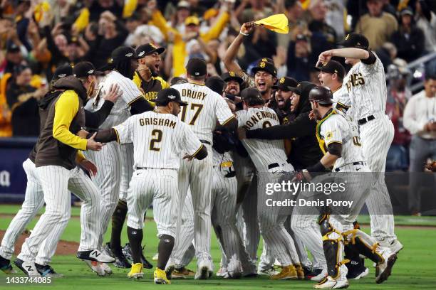 The San Diego Padres celebrate defeating the Los Angeles Dodgers 5-3 in game four of the National League Division Series at PETCO Park on October 15,...