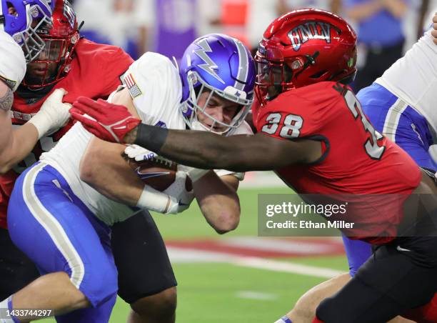 Running back Brad Roberts of the Air Force Falcons is tackled by linebacker Marsel McDuffie of the UNLV Rebels during their game at Allegiant Stadium...