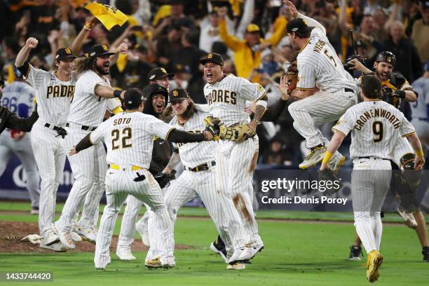 The San Diego Padres celebrate defeating the Los Angeles Dodgers 5-3 in game four of the National League Division Series at PETCO Park on October 15,...