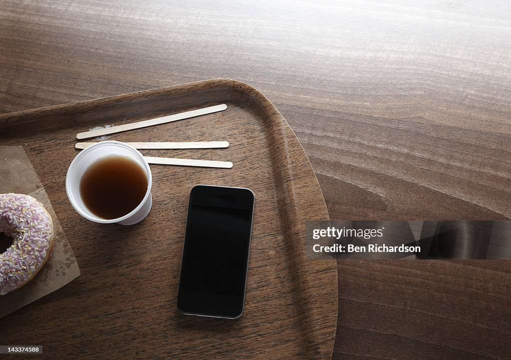 Smart phone on coffee tray