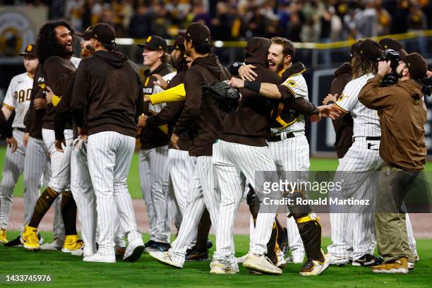 The San Diego Padres celebrate defeating the Los Angeles Dodgers 5-3 in game four of the National League Division Series at PETCO Park on October 15,...
