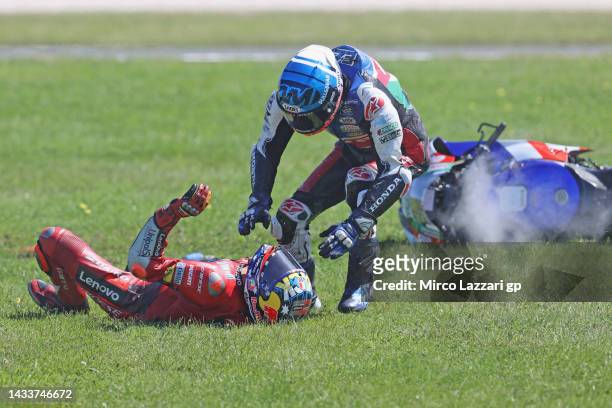 Alex Marquez of Spain and LCR Honda Castrol checks the condition of Jack Miller of Australia and Ducati Lenovo Team after crashed out during the...