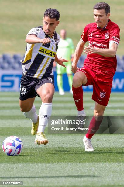Daniel Arzani of Macarthur FC kicks as Isaias Sanchez Cortes of Adelaide United defends during the round two A-League Men's match between Macarthur...