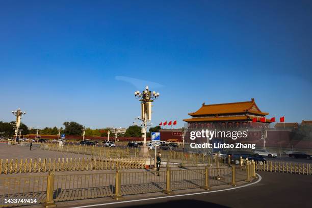 Members of security staff keep watch on Tiananmen Square before the opening session of the 20th National Congress of the Communist Party of China at...