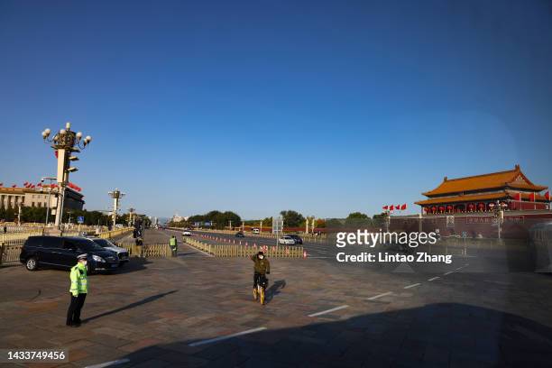 Members of security staff keep watch on Tiananmen Square before the opening session of the 20th National Congress of the Communist Party of China at...