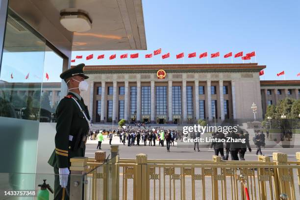 Member of security staff keeps watch on Tiananmen Square before the opening session of the 20th National Congress of the Communist Party of China at...