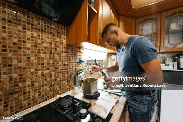 man in the kitchen cooking homemade bread - osteuropäischer abstammung stock-fotos und bilder