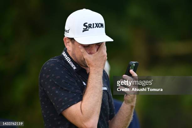 Keegan Bradley of the United States shows emotion as he talks with his family through FaceTime after winning the tournament following the final round...
