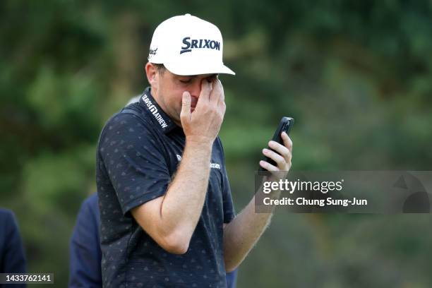 Keegan Bradley of the United States shows emotion as he talks with his family through FaceTime after winning the tournament following the final round...