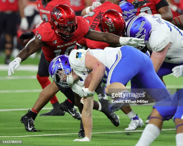 Linebacker Fred Thompkins of the UNLV Rebels tackles running back Owen Burk of the Air Force Falcons during their game at Allegiant Stadium on...