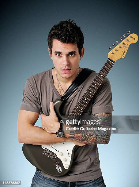 Portrait of American musician John Mayer posing with his signature Fender Stratocaster backstage at the Hard Rock Calling festival in London on June...