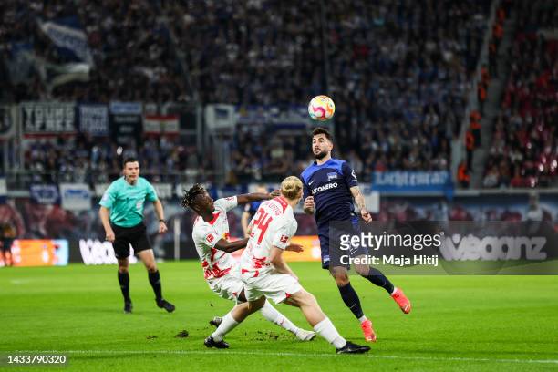 Mohammed Simakan, Xaver Schlager of Leipzig battle for possession with Marco Richter of Hertha Berlin during the Bundesliga match between RB Leipzig...